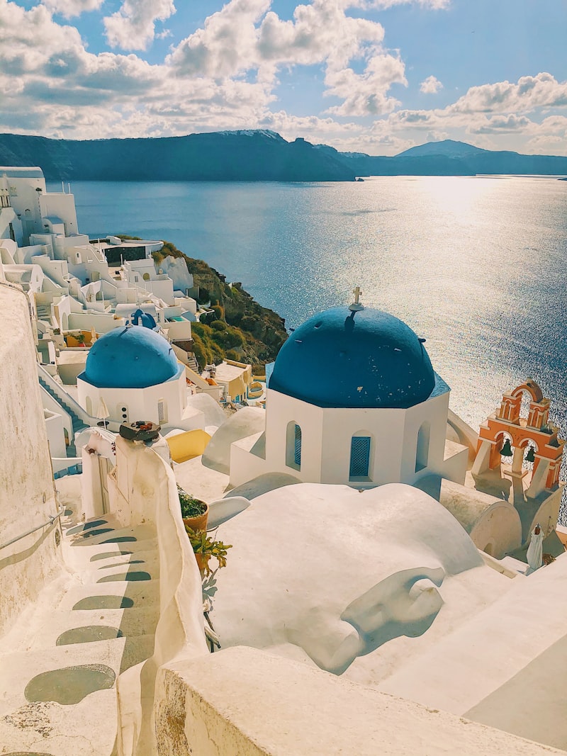 Hiker on the cliff-edge trail overlooking Santorini's volcanic caldera