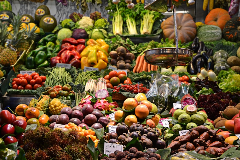 Colorful open-air market stalls with fresh produce and flowers