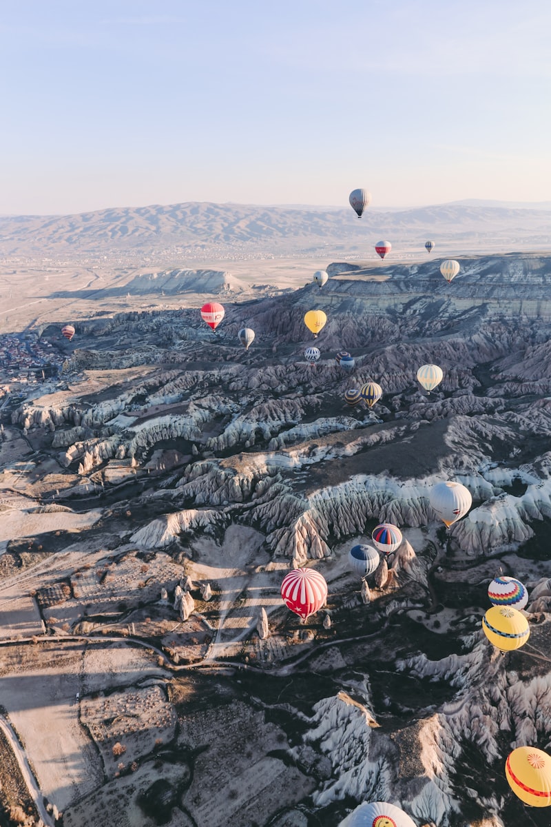 Hot air balloons floating over the Valley of the Kings at dawn