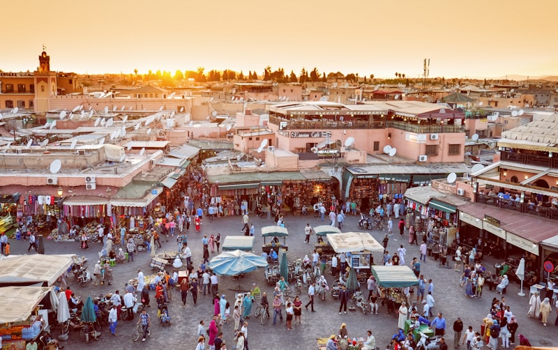 Bustling Jemaa el-Fnaa square at dusk with food stalls and crowds in Marrakech