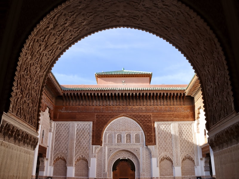 Ornate courtyard with zellige tilework and carved stucco at Bahia Palace Marrakech