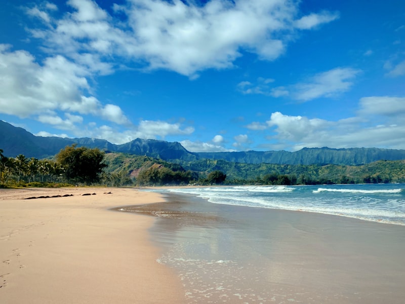 Hanalei Bay crescent beach with mountains on Kauai