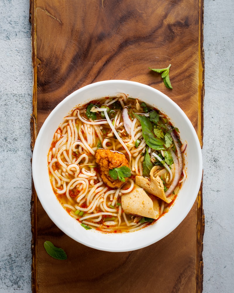 Bowl of pho with fresh herbs at a street stall in Hanoi