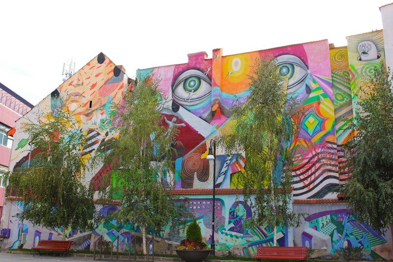 Large colorful street art mural on a building facade
