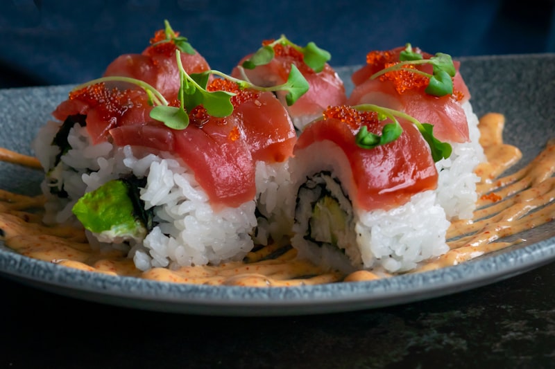 Fresh sushi rolls and nigiri being prepared in a kitchen