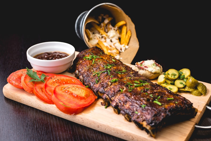 Korean BBQ meats grilling on a table grill with banchan side dishes