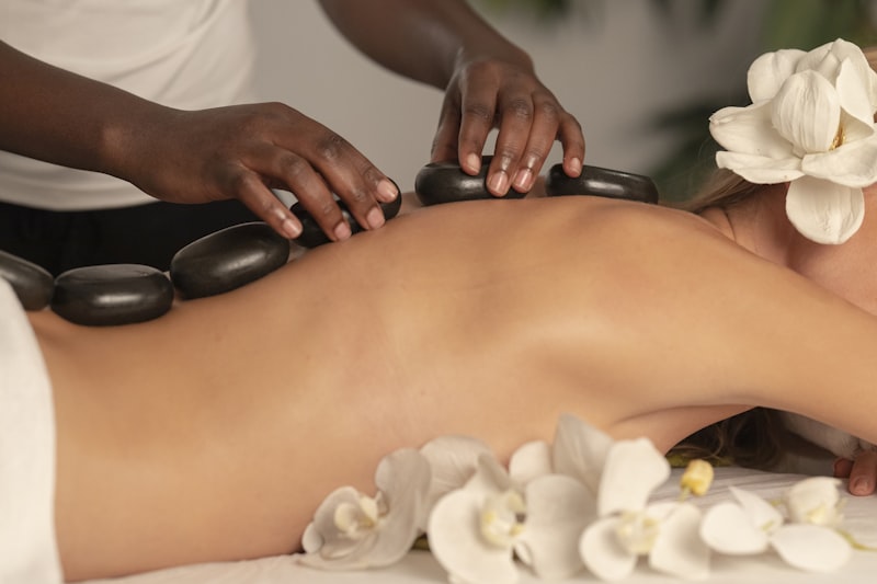 Relaxing massage table in a tiled Moroccan riad spa with candles and rose petals